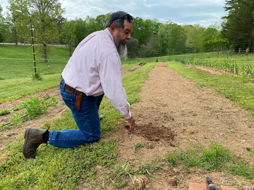 Rafael Bravo realized his dream of retiring to start a farm in Polk County. Here he tends to a vegetable bed.