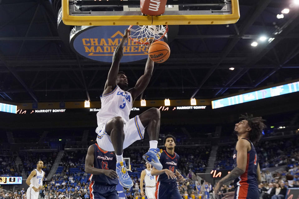 UCLA forward Adem Bona (3) dunks against Pepperdine during the first half of an NCAA college basketball game Wednesday, Nov. 23, 2022, in Los Angeles. (AP Photo/Marcio Jose Sanchez)