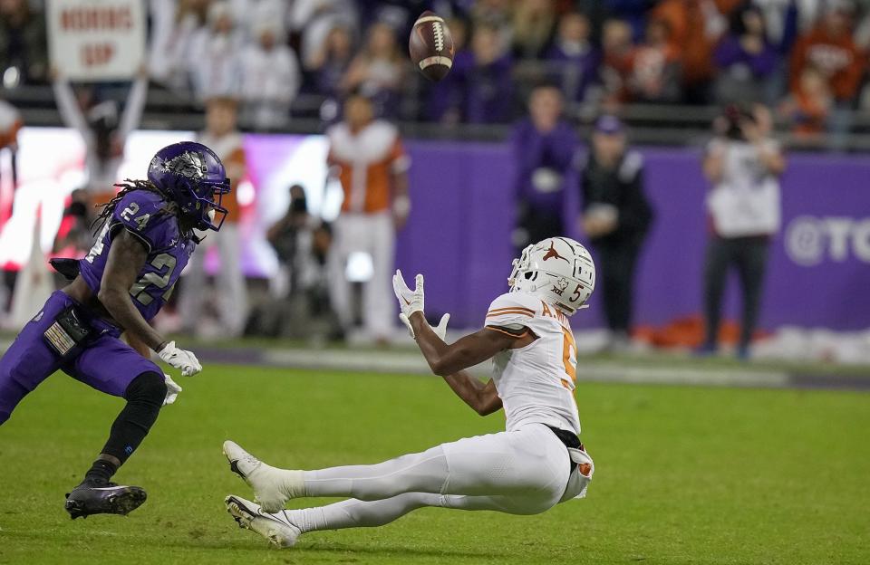 Texas wide receiver Adonai Mitchell comes up with a critical 35-yard catch as he falls to the ground on third-and-12 near the end of the TCU game Nov. 11. The catch helped Texas run out the clock and escape Fort Worth with a 29-26 win.