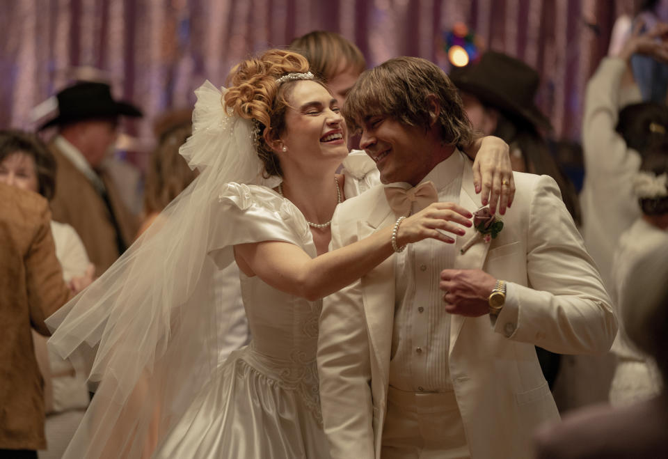 This image released by A24 shows Lily James, left, and Zac Efron in a scene from "The Iron Claw." (Brian Roedel/A24 via AP)