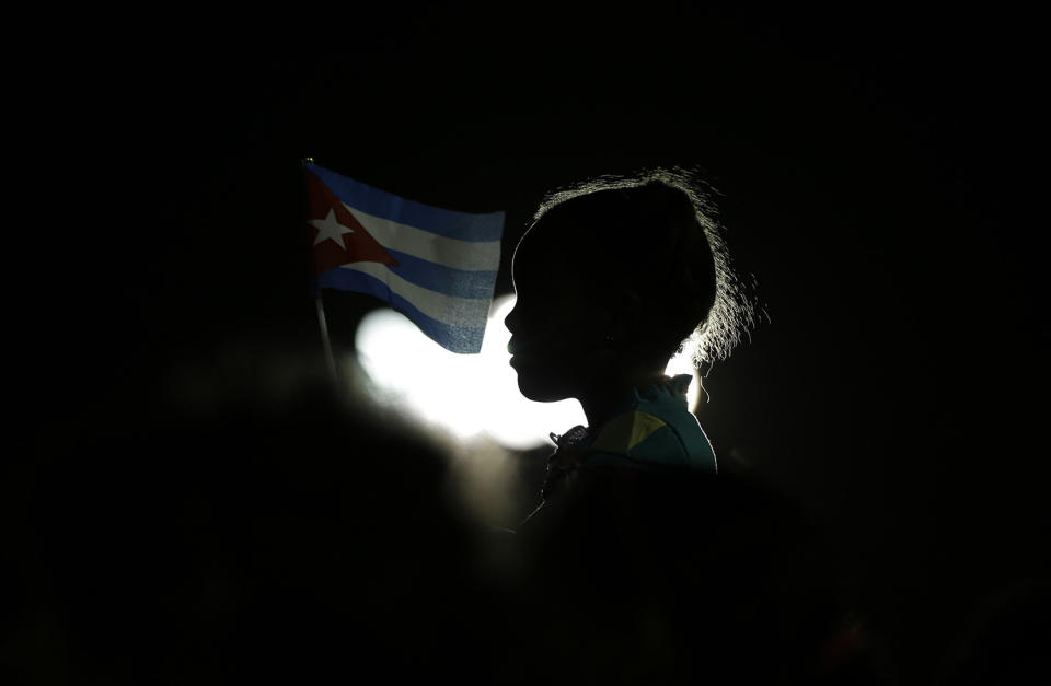 Young girl holds a Cuban flag