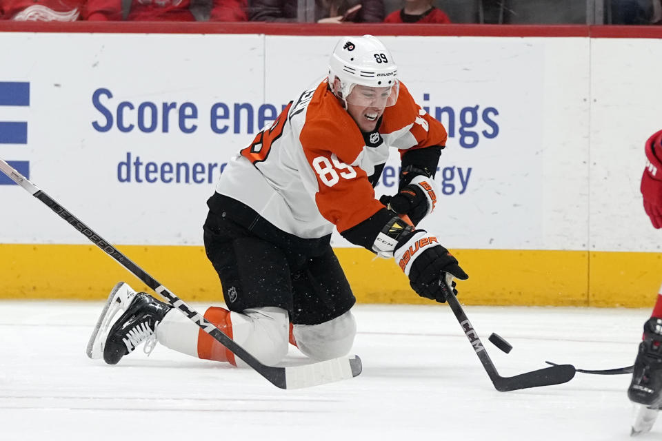 Philadelphia Flyers right wing Cam Atkinson (89) reaches for the puck during the first period of an NHL hockey game against the Detroit Red Wings, Thursday, Jan. 25, 2024, in Detroit. (AP Photo/Carlos Osorio)