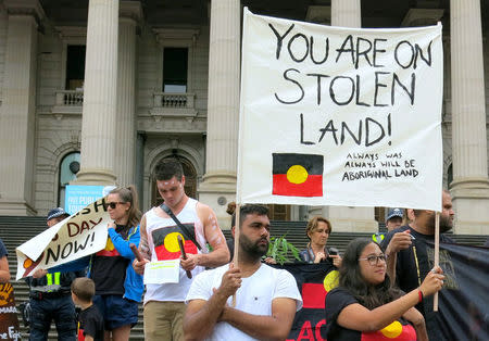 Aboriginal protesters hold signs as they demonstrate outside the Victorian State Parliament on Australia Day in Melbourne, Australia, January 26, 2017. AAP/Alex Murray/via REUTERS