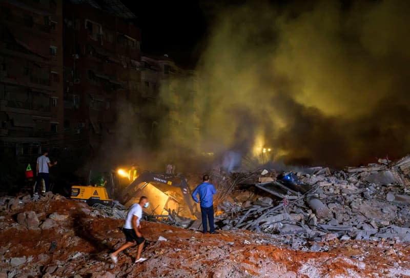 Rescue workers gather at the site of a massive Israeli air attack on pro-Iranian Hezbollah headquarters in the southern suburbs of Beirut. Marwan Naaman/dpa