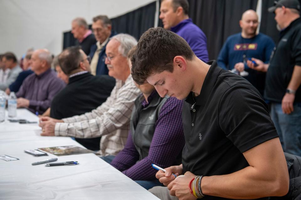 Colson Montgomery signs a baseball during the 23rd annual Tri-State Hot Stove League’s Night of Memories at the University of Evansville’s Carson Center Saturday, Jan. 21, 2023. 