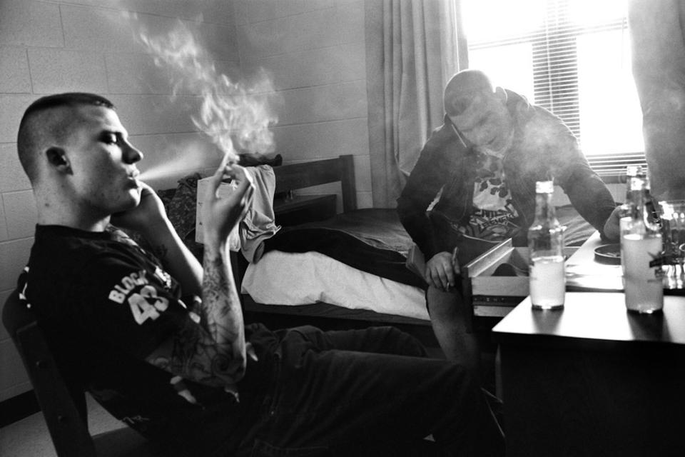Specialists Ryan Cooley (left) and Adam Ramsey (right) smoke cigarettes in the infantry barracks, which houses unmarried soldiers, at Fort Drum, N.Y. January 2010.