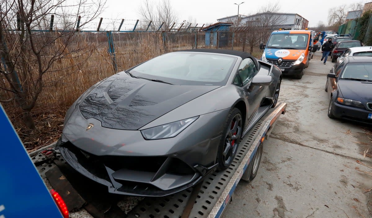 A Lamborghini belonging to Tate is towed away in Bucharest (EPA)