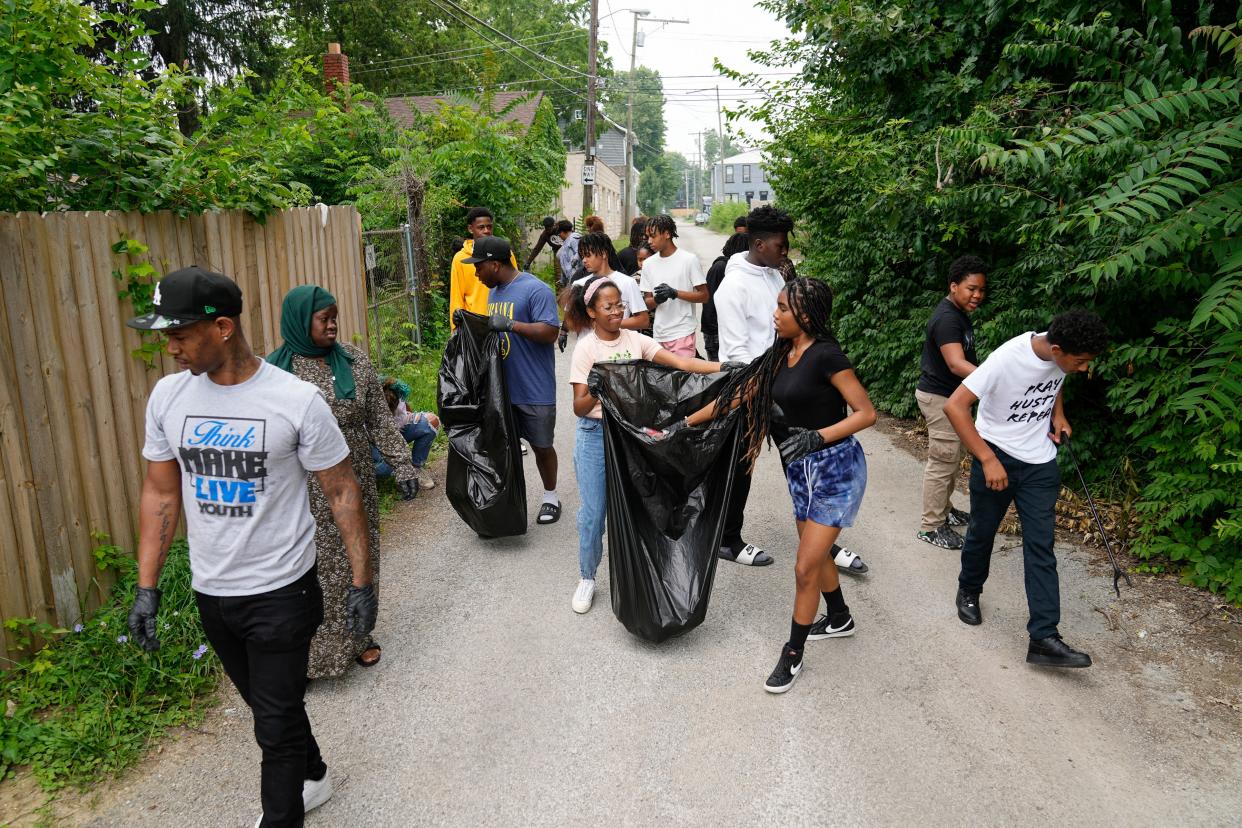 A group of 28 participants in the Think Make Live Youth program walks through the streets of Columbus' Driving Park neighborhood picking up trash on July 17, 2023, as part of the community service element to the six-week summer program. Columbus provided a grant for the program so that youth and young adults ages 14-24 are paid to learn about workforce development, social justice, leadership and more.