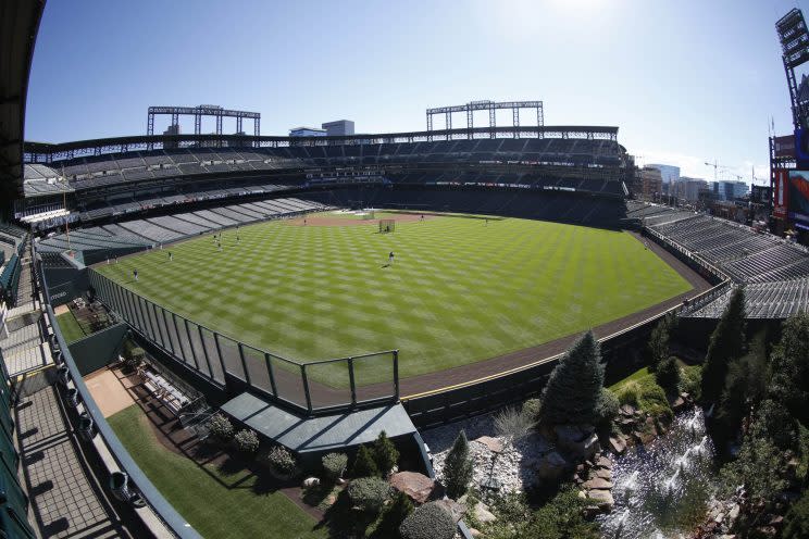 Players warm up before the first inning of a baseball game Monday, Sept. 19, 2016 in Denver. (AP Photo/David Zalubowski)