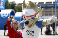 <p>Fans pose with a Mascot ahead of the opening match of the 2018 FIFA World Cup </p>