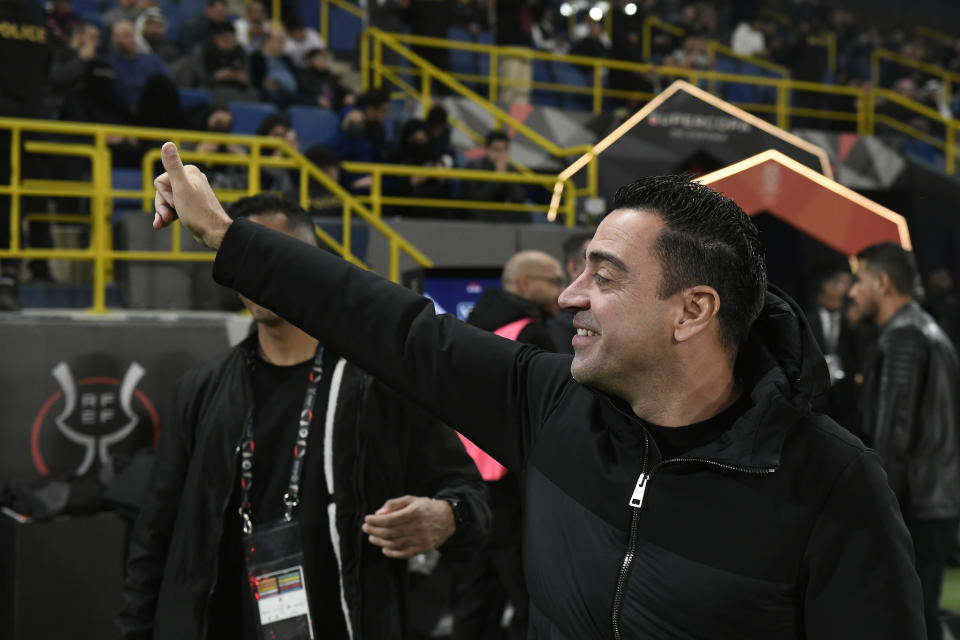 Barcelona's head coach Xavi Hernandez greets fans before the Spanish Super Cup semi final soccer match between Osasuna and Barcelona at Al Awal Park Stadium in Riyadh, Saudi Arabia, Thursday, Jan. 11, 2024. (AP Photo)