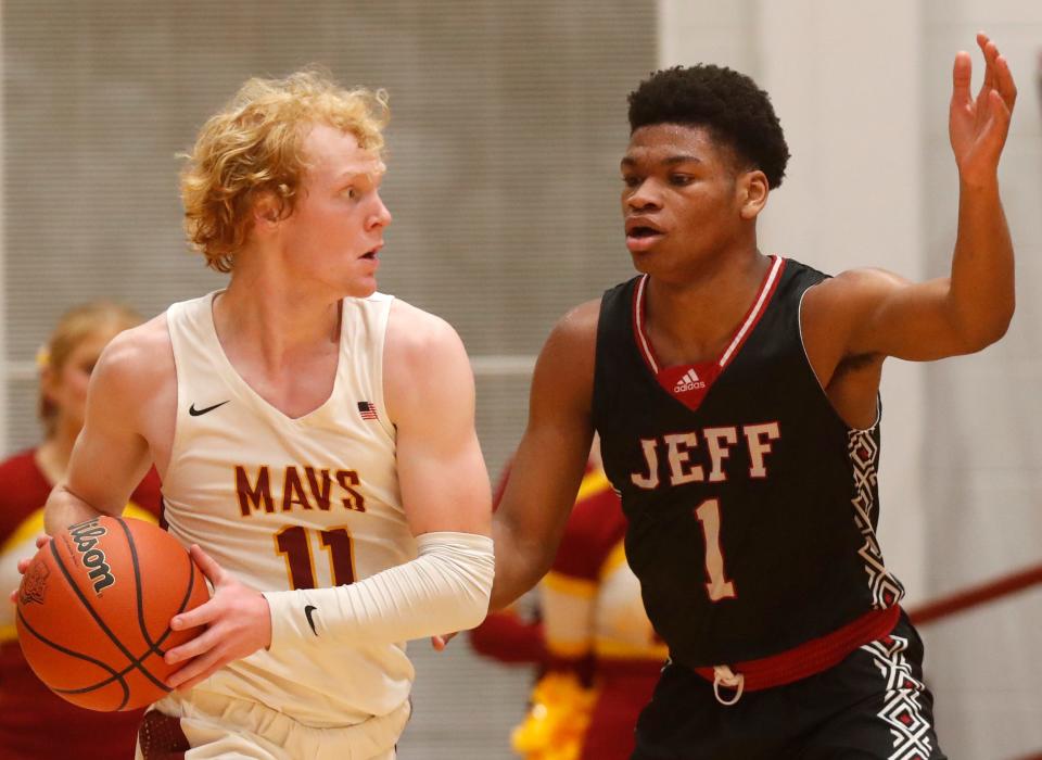 McCutcheon Mavericks guard Eli Swank (11) is defended by Lafayette Jeff Bronchos Ah'keem Wilson (01) during the IHSAA boy’s basketball game, Thursday, Feb. 2, 2023, at McCutcheon High School in Lafayette, Ind. McCutcheon won 64-55.