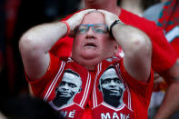 Soccer Football - Liverpool fans watch the Champions League Final - Liverpool, Britain - May 26, 2018 Liverpool fan inside Anfield reacts after Mohamed Salah sustains an injury REUTERS/Andrew Yates