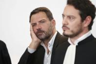 Former trader Jerome Kerviel (L) and his lawyer David Koubbi (R) stand inside the courthouse in Versailles, France, September 23, 2016. REUTERS/Charles Platiau