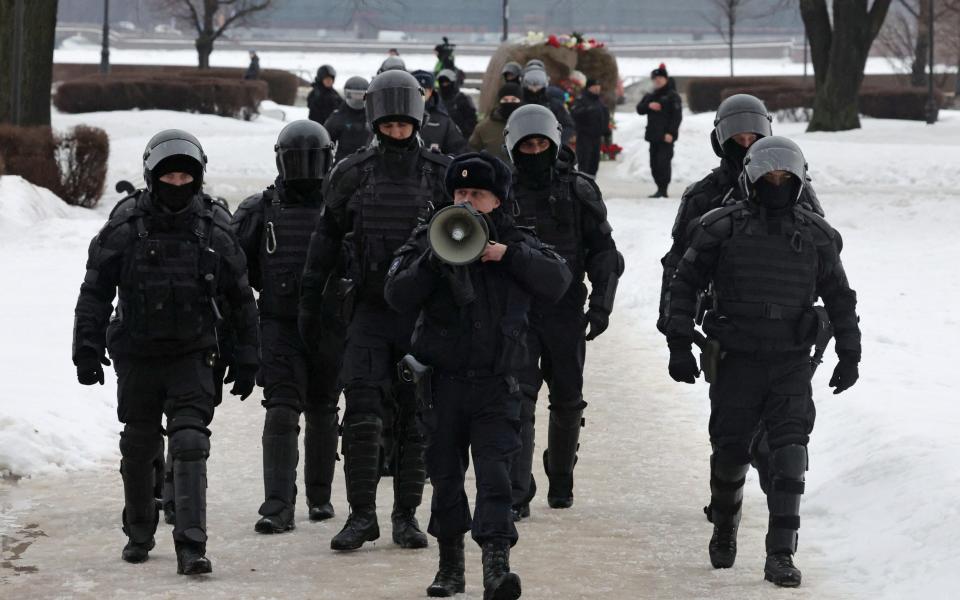 Officers arrive to disperse and arrest people gathering to honour the memory of  Navalny