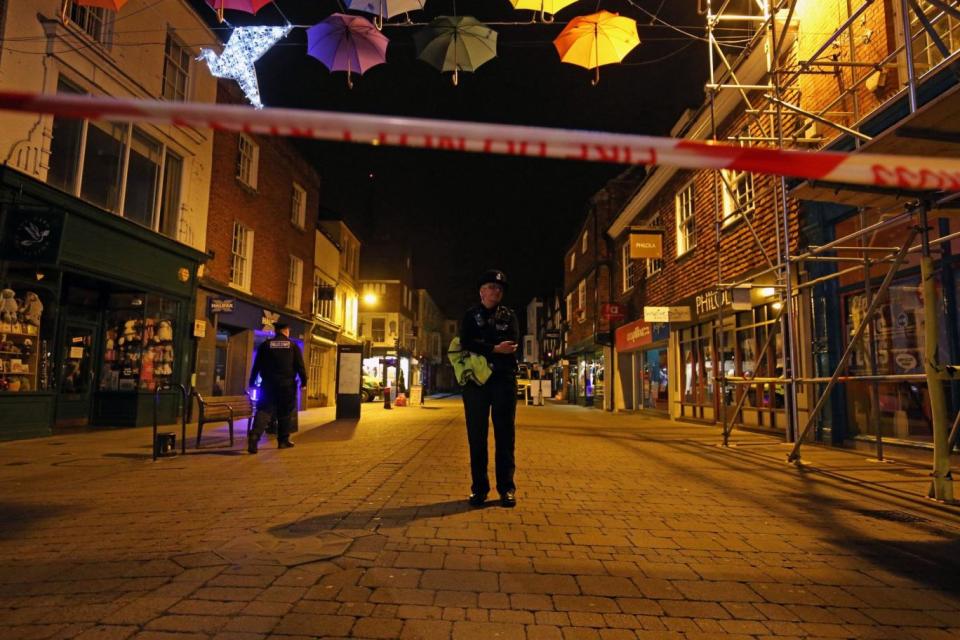 Police officers behind a cordon on the High Street in Salisbury (PA)