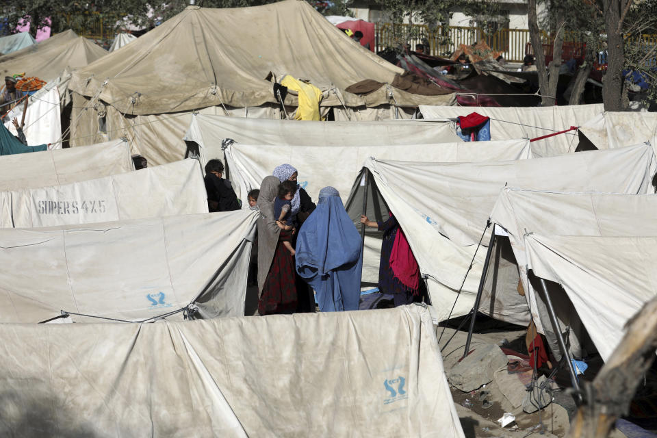 Internally displaced Afghans from northern provinces, who fled their home due to fighting between the Taliban and Afghan security personnel, take refuge in a public park Kabul, Afghanistan, Friday, Aug. 13, 2021. The Taliban have completed their sweep of the country's south on Friday, as they took four more provincial capitals in a lightning offensive that is gradually encircling Kabul, just weeks before the U.S. is set to officially end its two-decade war. (AP Photo/Rahmat Gul)