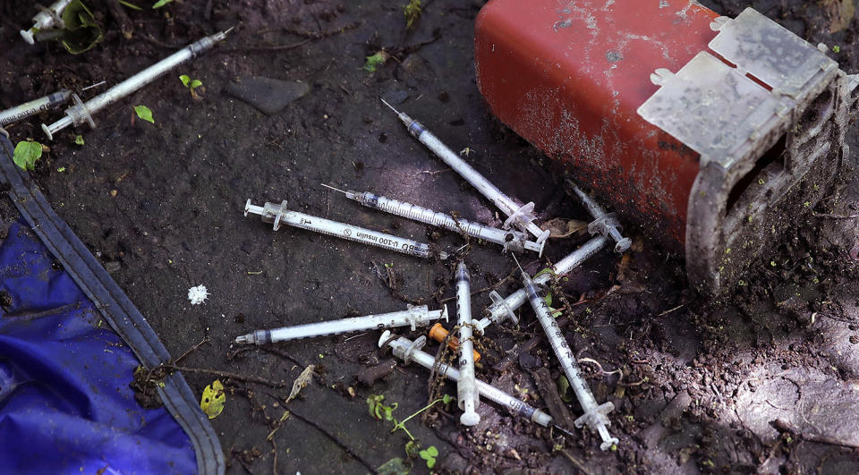 <p>Discarded used hypodermic needles without protective sheaths at an encampment where opioid addicts shoot up along the Merrimack River in Lowell, Mass. Syringes left by drug users amid the heroin crisis are turning up everywhere. They hide in weeds along hiking trails and in playground grass, get washed into rivers and onto beaches, and lie scattered about in baseball dugouts and on sidewalks and streets. There are reports of children finding them and getting poked. (Photo: Charles Krupa/AP) </p>