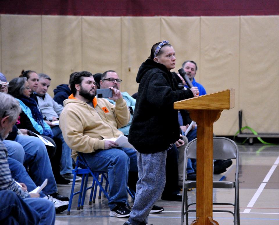 A resident asks a question during a special Rittman City Council meeting Monday, where more than 150 people showed up to question city leaders about the 1.5% income tax they had been paying for the last 15 years, which should have been reset to a 1% rate.