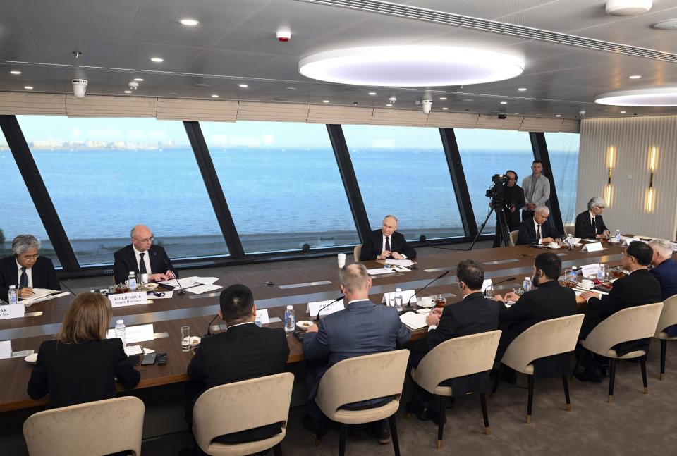 Russian President Vladimir Putin, center right, speaks to senior news leaders of international news agencies on the sidelines of the St. Petersburg International Economic Forum at the Lakhta Center skyscraper, the headquarters of Russian gas monopoly Gazprom in St. Petersburg, Russia, on Wednesday, June 5, 2024. (Vladimir Astapkovich, Sputnik, Kremlin Pool Photo via AP)