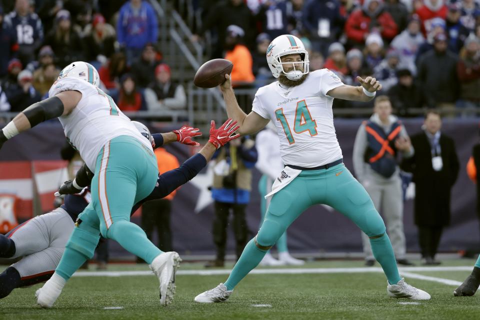 Miami Dolphins quarterback Ryan Fitzpatrick passes under pressure in the first half of an NFL football game against the New England Patriots, Sunday, Dec. 29, 2019, in Foxborough, Mass. (AP Photo/Elise Amendola)