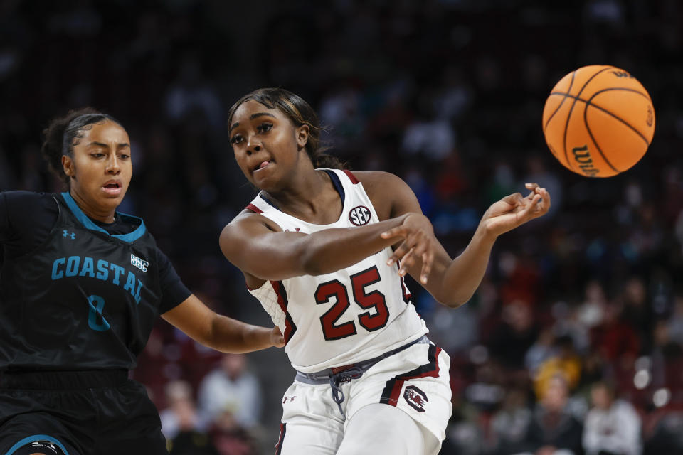 South Carolina guard Raven Johnson (25) passes against Coastal Carolina guard Helena Delaruelle during the first half of an NCAA college basketball game in Columbia, S.C., Wednesday, Dec. 21, 2022. (AP Photo/Nell Redmond)