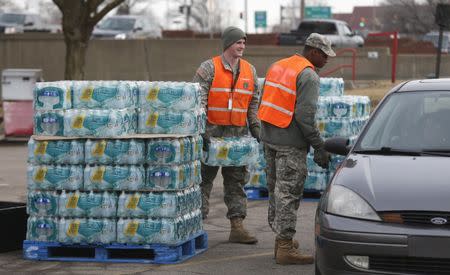 Michigan National Guardsmen distribute bottled water to Flint residents at a fire station in Flint, Michigan February 7, 2016. REUTERS/Rebecca Cook