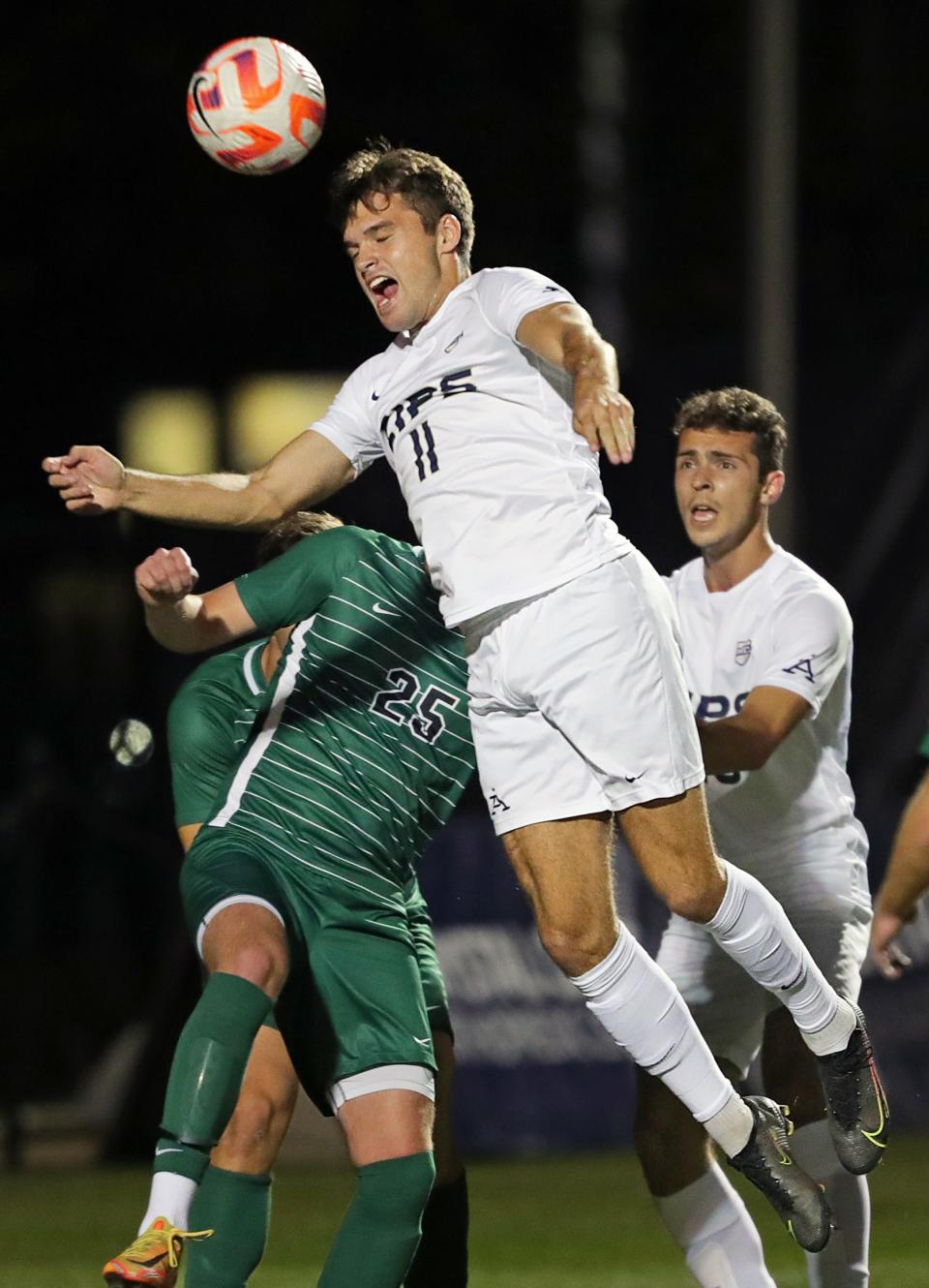 Akron defender Will Jackson (11) heads a corner kick into the goal over Cleveland St. midfielder Josh Davis (25) to put the Zips on the board during the first half of an NCAA college soccer game, Tuesday, Oct. 25, 2022, in Akron, Ohio.