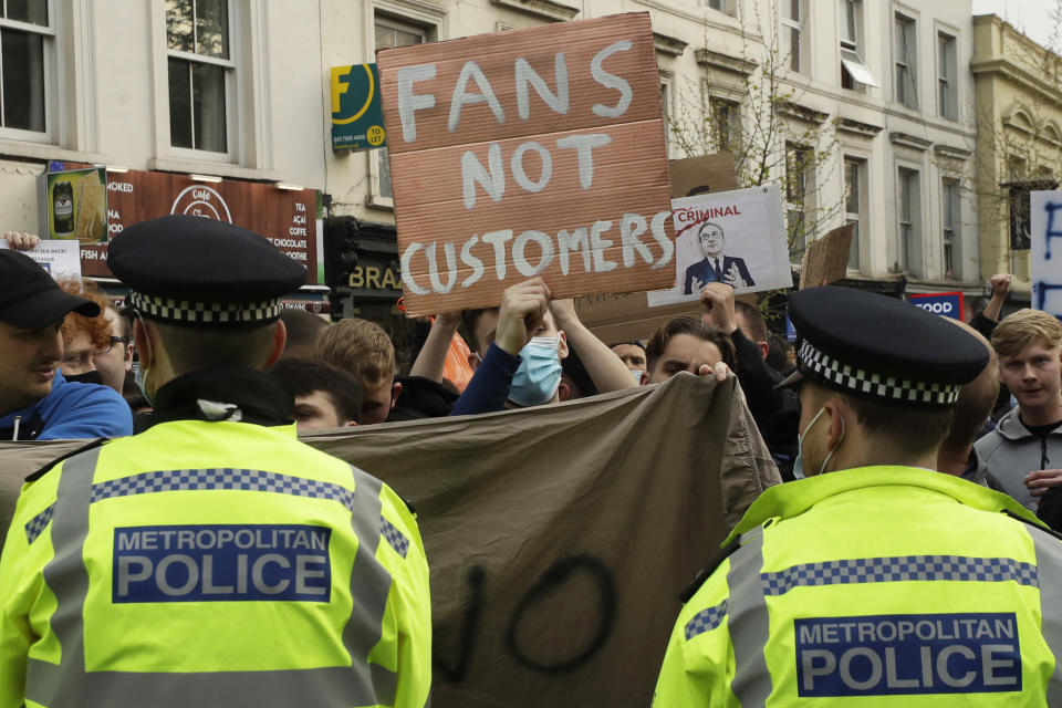 Chelsea fans protest outside Stamford Bridge stadium in London, against Chelsea's decision to be included amongst the clubs attempting to form a new European Super League, Tuesday, April 20, 2021. Reaction to the proposals from 12 clubs to rip up European soccer by forming a breakaway Super League has ranged from anger and condemnation to humor and sarcasm. (AP Photo/Matt Dunham)