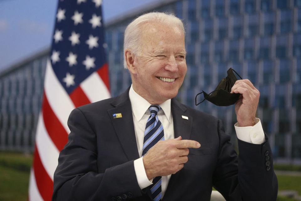 US President Joe Biden takes off his face mask he meets with NATO Secretary General during a NATO summit at the North Atlantic Treaty Organization (NATO) headquarters in Brussels on June 14, 2021. - The 30-nation alliance hopes to reaffirm its unity and discuss increasingly tense relations with China and Russia, as the organization pulls its troops out after 18 years in Afghanistan. (Photo by Stephanie LECOCQ / POOL / AFP) (Photo by STEPHANIE LECOCQ/POOL/AFP via Getty Images)