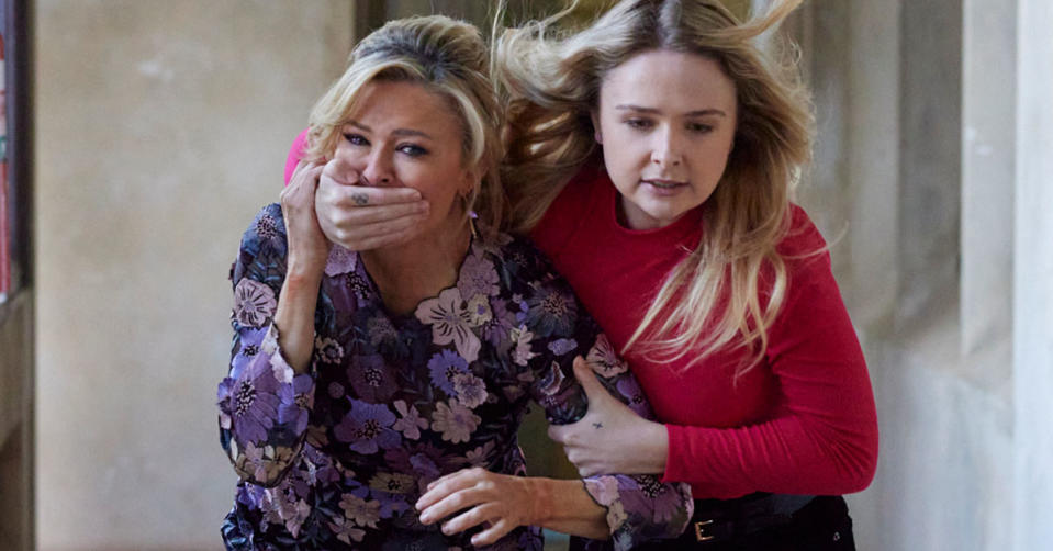 Marilyn is pulled away by Heather holding her hand over her mouth on Home and Away