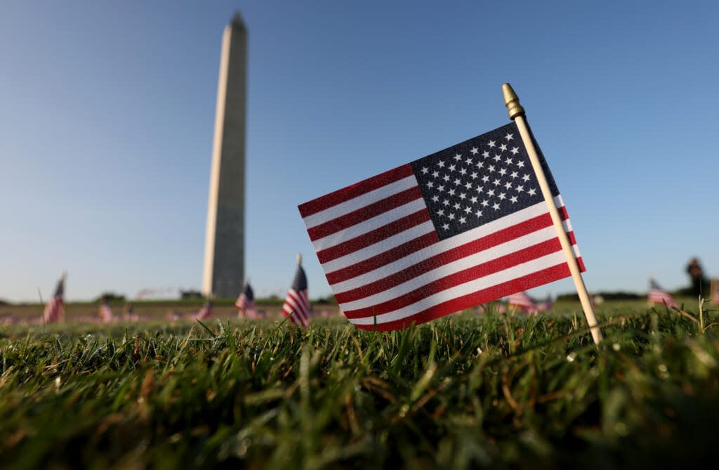 American flags at a COVID Memorial Project installation of 20,000 flags are shown on the National Mall as the United States crosses the 200,000 lives lost in the COVID-19 pandemic September 22, 2020 in Washington, DC. (Photo by Win McNamee/Getty Images)