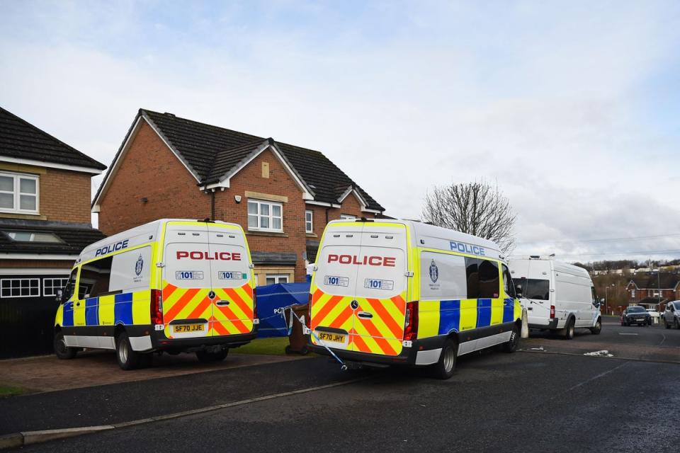 Police vans outside the couple’s home on Thursday (AFP via Getty Images)