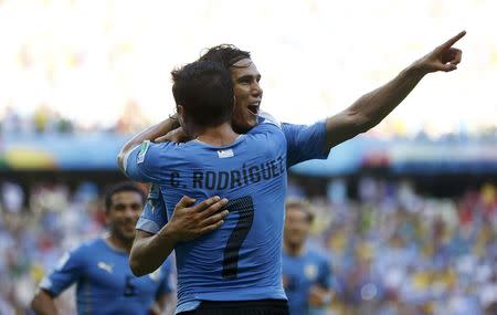 Uruguay's Edinson Cavani celebrates with Cristian Rodriguez (7) after Cavani's penalty goal during their 2014 World Cup Group D soccer match against Costa Rica at the Castelao stadium in Fortaleza June 14, 2014. REUTERS/Dominic Ebenbichler