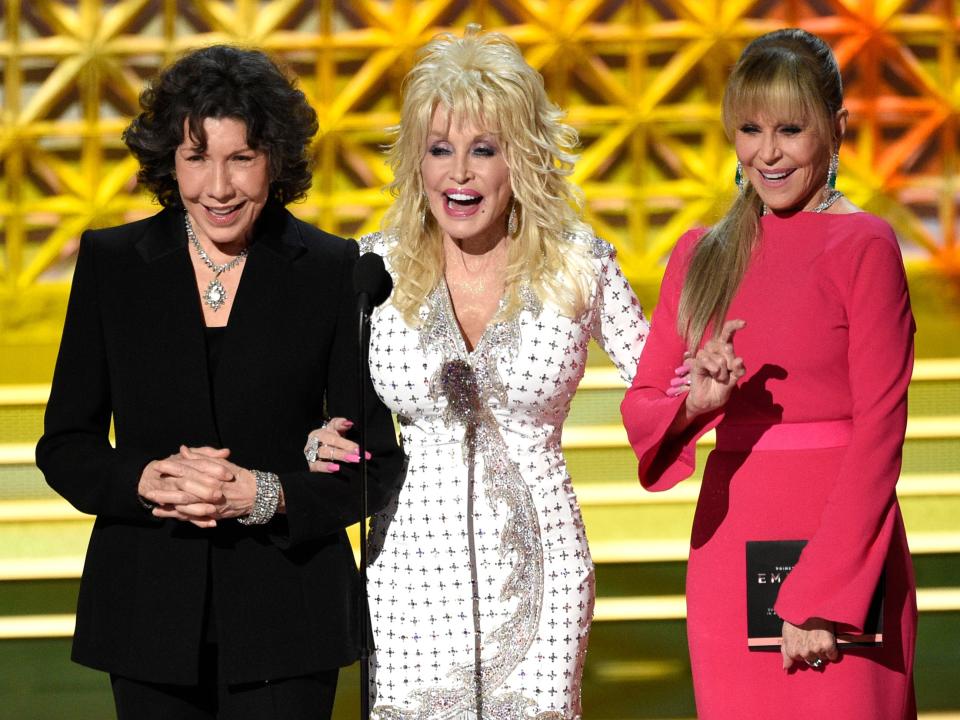 Lily in a black suit, Dolly in a white dress, and Jane in a pink dress.