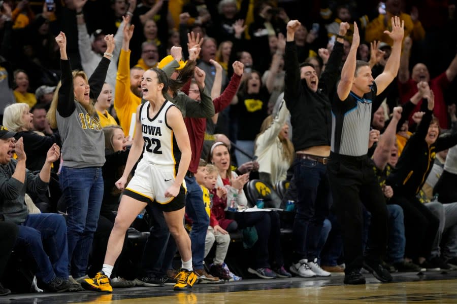 Iowa guard Caitlin Clark (22) reacts after breaking the NCAA women’s career scoring record during the first half of the team’s college basketball game against Michigan, Thursday, Feb. 15, 2024, in Iowa City, Iowa. (AP Photo/Matthew Putney)