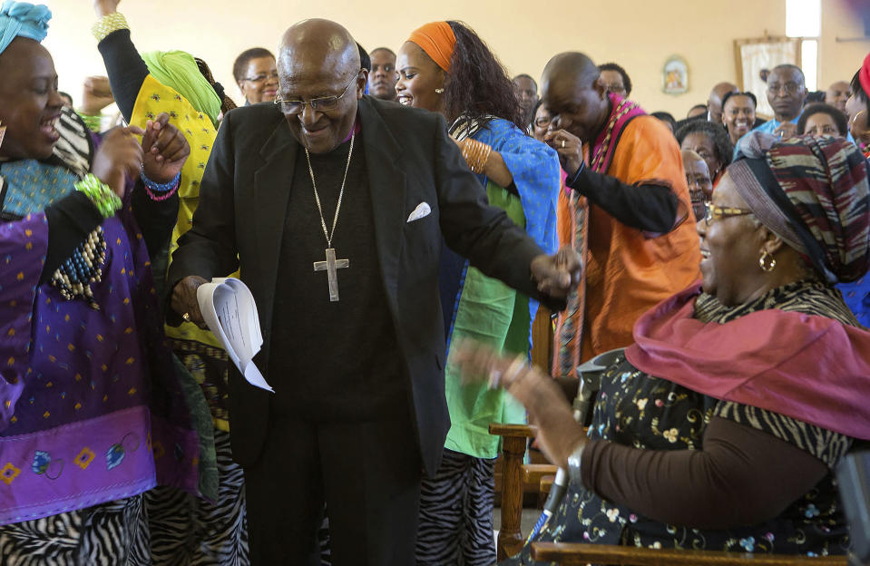 FILE - Anglican Archbishop Emeritus Desmond Tutu, center, breaks into dance after renewing his wedding vows to his wife of 60 years, Leah, right, during a service in Soweto, Johannesburg, Aug. 2015. When Tutu died Sunday, Dec. 26, 2021 at age 90, he was remembered as a Nobel laureate, a spiritual compass, a champion of the anti-apartheid struggle who turned to other global causes after Nelson Mandela, another moral heavyweight, became South Africa's first Black president. (AP Photo, File)