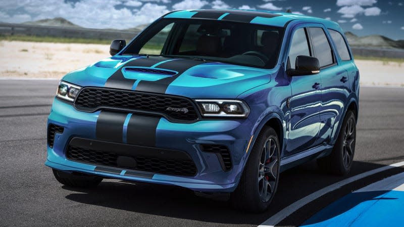 A blue Dodge Durango SRT Hellcat with black stripes driving on a racetrack.