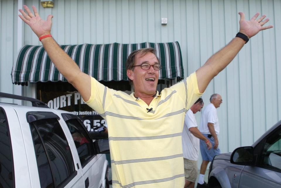 William Dillon throws his hands in the air after having his ankle monitor removed in December 2008, when the state decided to drop all charges against him.