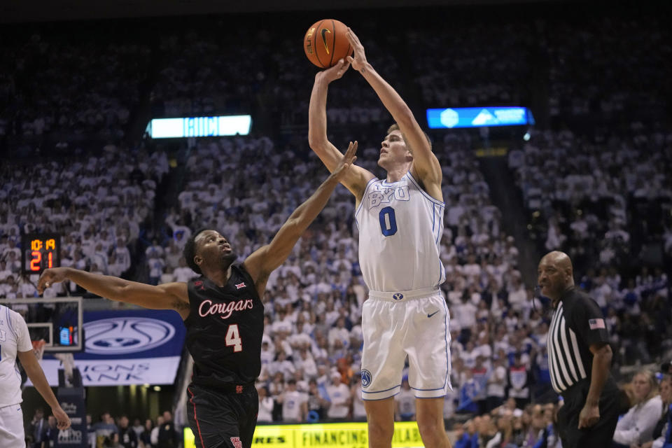 BYU forward Noah Waterman (0) shoots as Houston guard L.J. Cryer (4) defends during the second half of an NCAA college basketball game Tuesday, Jan. 23, 2024, in Provo, Utah. (AP Photo/Rick Bowmer)