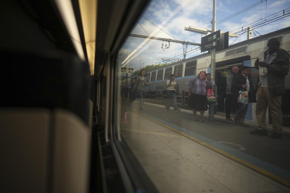 Passengers are visible through a window of a high-speed train in Paris, France, Monday, May 27, 2024. (AP Photo/Daniel Cole)