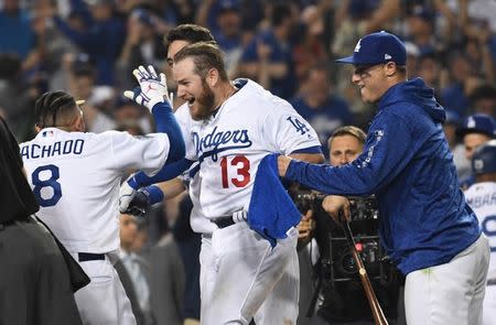 Los Angeles Dodgers first baseman Max Muncy (13) celebrates with teammates after hitting a walk off home run in the 18th inning. (AP) 