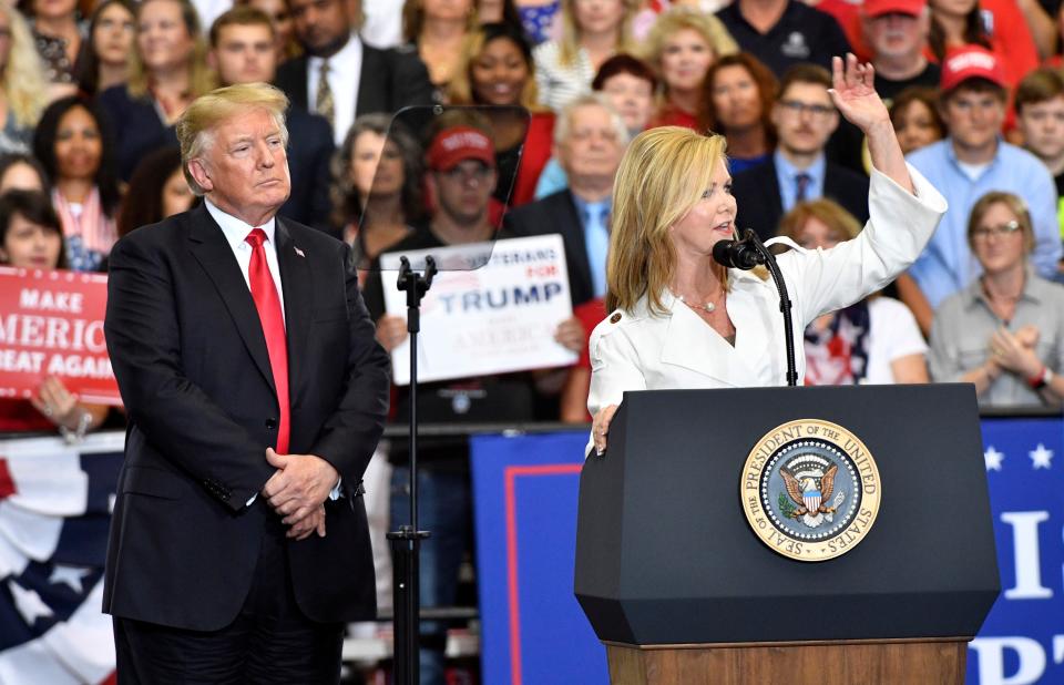 U.S. Senate candidate Marsha Blackburn speaks to the crowd as President Donald Trump looks on during a rally at Municipal Auditorium, Tuesday, May 29, 2018, in Nashville, Tenn.