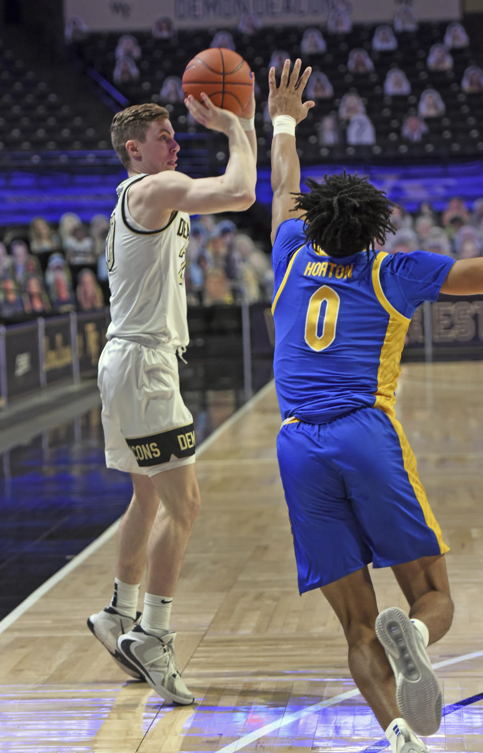 Wake Forest's Jonah Antonio sinks a 3-point shot under pressure from Pittsburgh's Ithiel Horton during an NCAA college basketball game Saturday, Jan. 23, 2021, in Winston-Salem, N.C. (Walt Unks/The Winston-Salem Journal via AP)