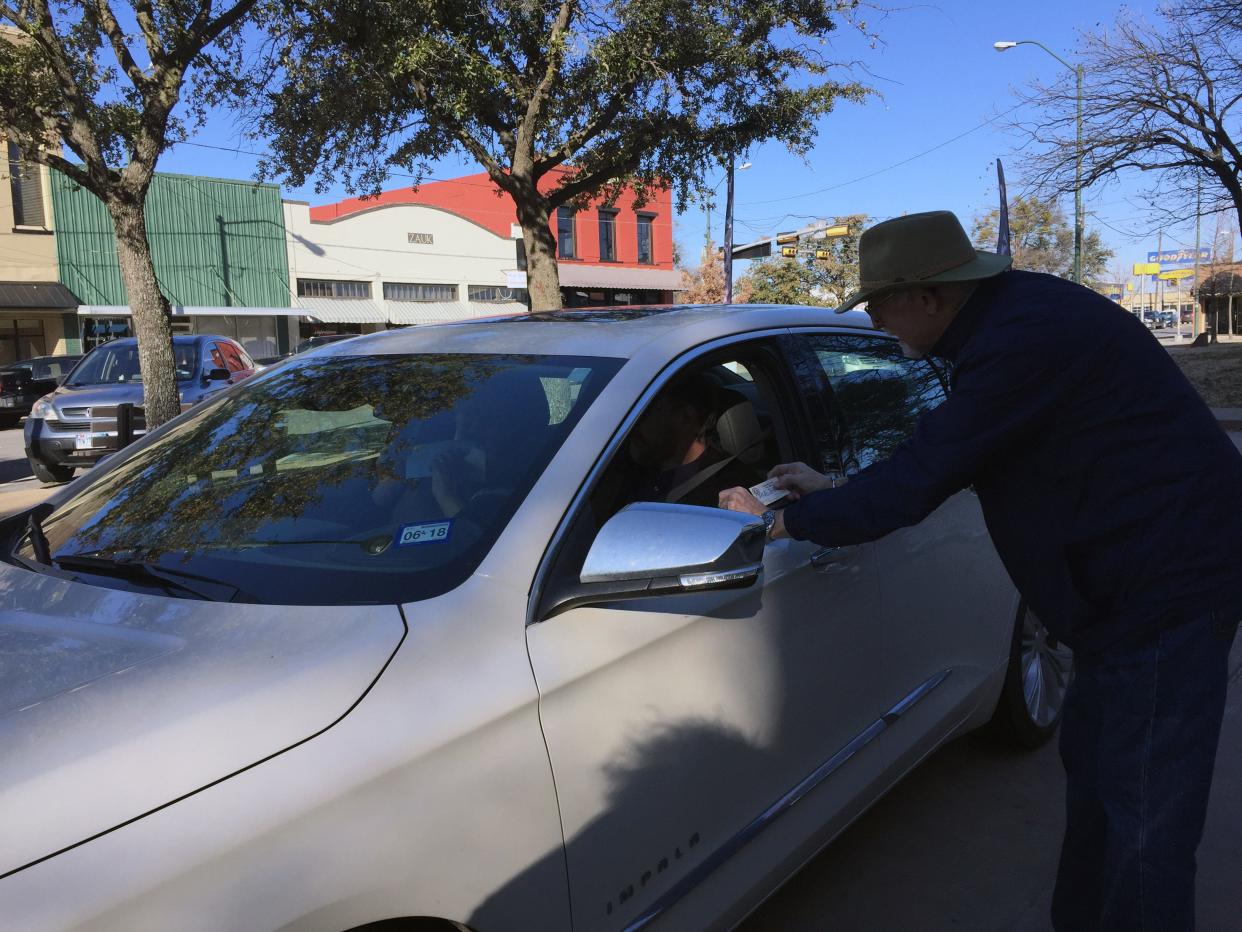 Grayson County Tax Assessor Collector Bruce Stidham accepts a tax payment in the 2019 drive-thru tax payment event.