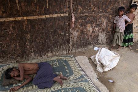 Muhammad Alam, who is suffering from a diarrhoea for over a week, lies on a mat in front of his room at the Dar Paing camp for internally displaced people in Sittwe, Rakhine state, April 24, 2014. REUTERS/Minzayar