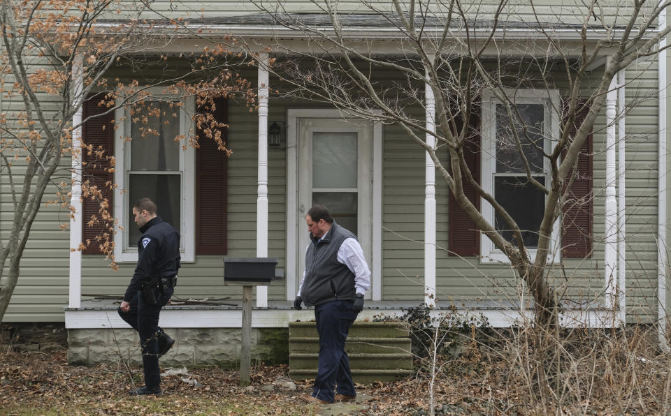 Law enforcement officers walk around a vacant house in Port Clinton, Ohio where the body of Harley Dilly, 14, was found inside the chimney. Source: Jeremy Wadsworth/The Blade via AP