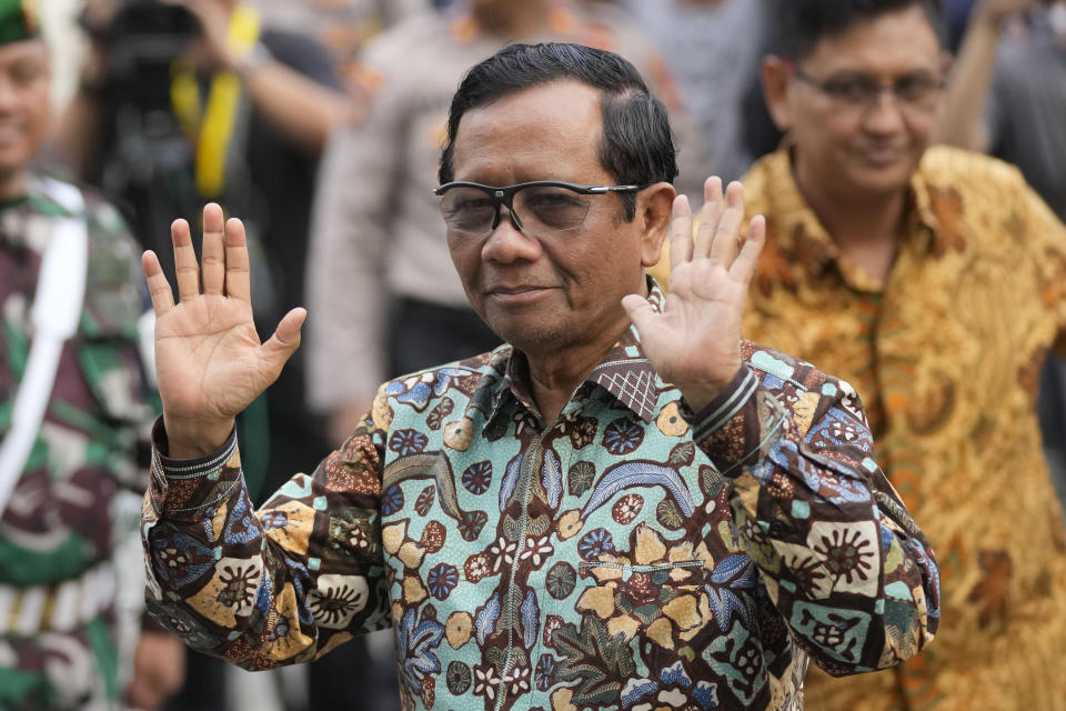 Vice presidential candidate who is also Indonesia's top Security Minister Mohamad Mahfud, popularly known as Mahfud MD, waves at reporters upon arrival for the medical check up required for his candidacy in the upcoming presidential election, at Gatot Subroto Army Hospital in Jakarta, Indonesia, Sunday, Oct. 22, 2023. The world's third-largest democracy is holding its legislative and presidential elections on Feb. 14, 2024. (AP Photo/Dita Alangkara)