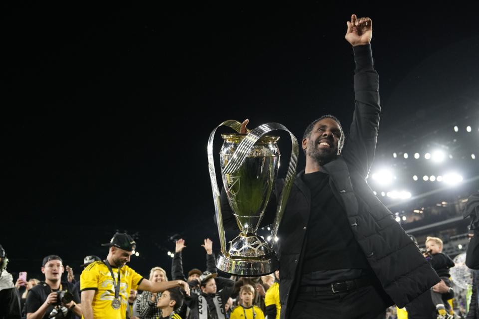 Crew coach Wilfried Nancy hoists the Philip J. Anschutz Trophy after defeating the Los Angeles FC in the 2023 MLS Cup.