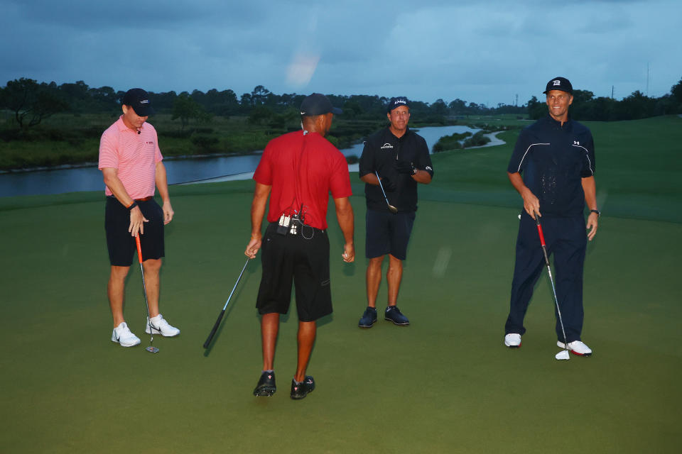 HOBE SOUND, FLORIDA - MAY 24: Tiger Woods and former NFL player Peyton Manning celebrate defeating Phil Mickelson and NFL player Tom Brady of the Tampa Bay Buccaneers on the 18th green during The Match: Champions For Charity at Medalist Golf Club on May 24, 2020 in Hobe Sound, Florida. (Photo by Mike Ehrmann/Getty Images for The Match)